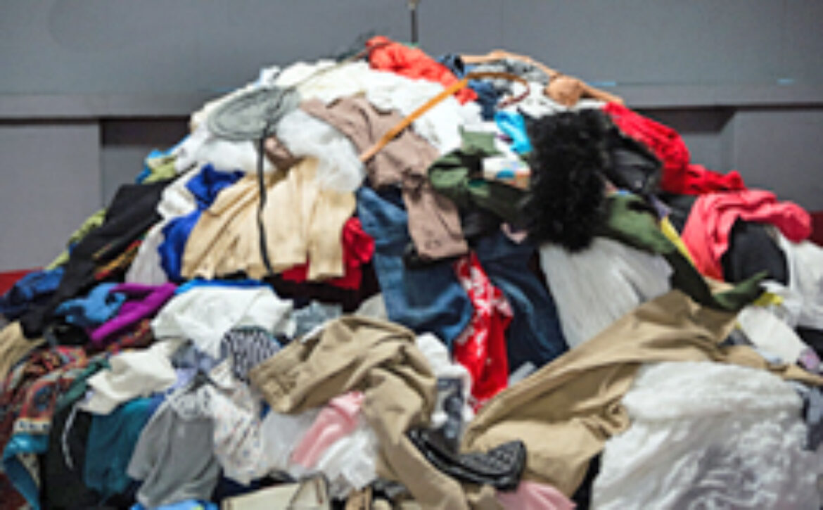 Installation of Pile of old worn clothes during Fashion revoluti