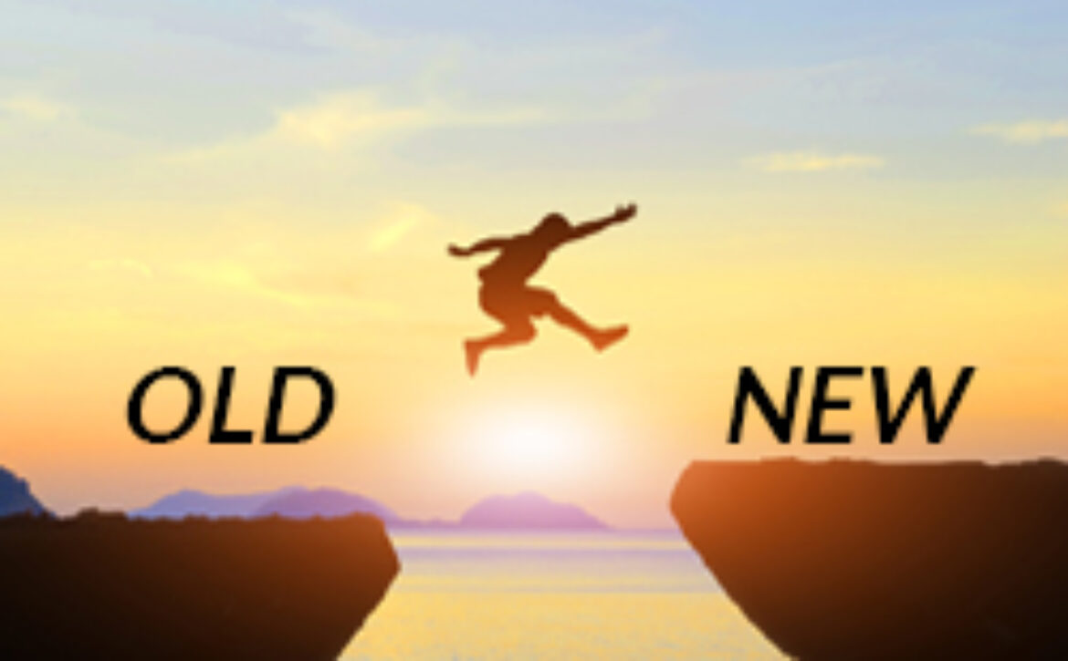 Men jump cliff sun light over silhouette